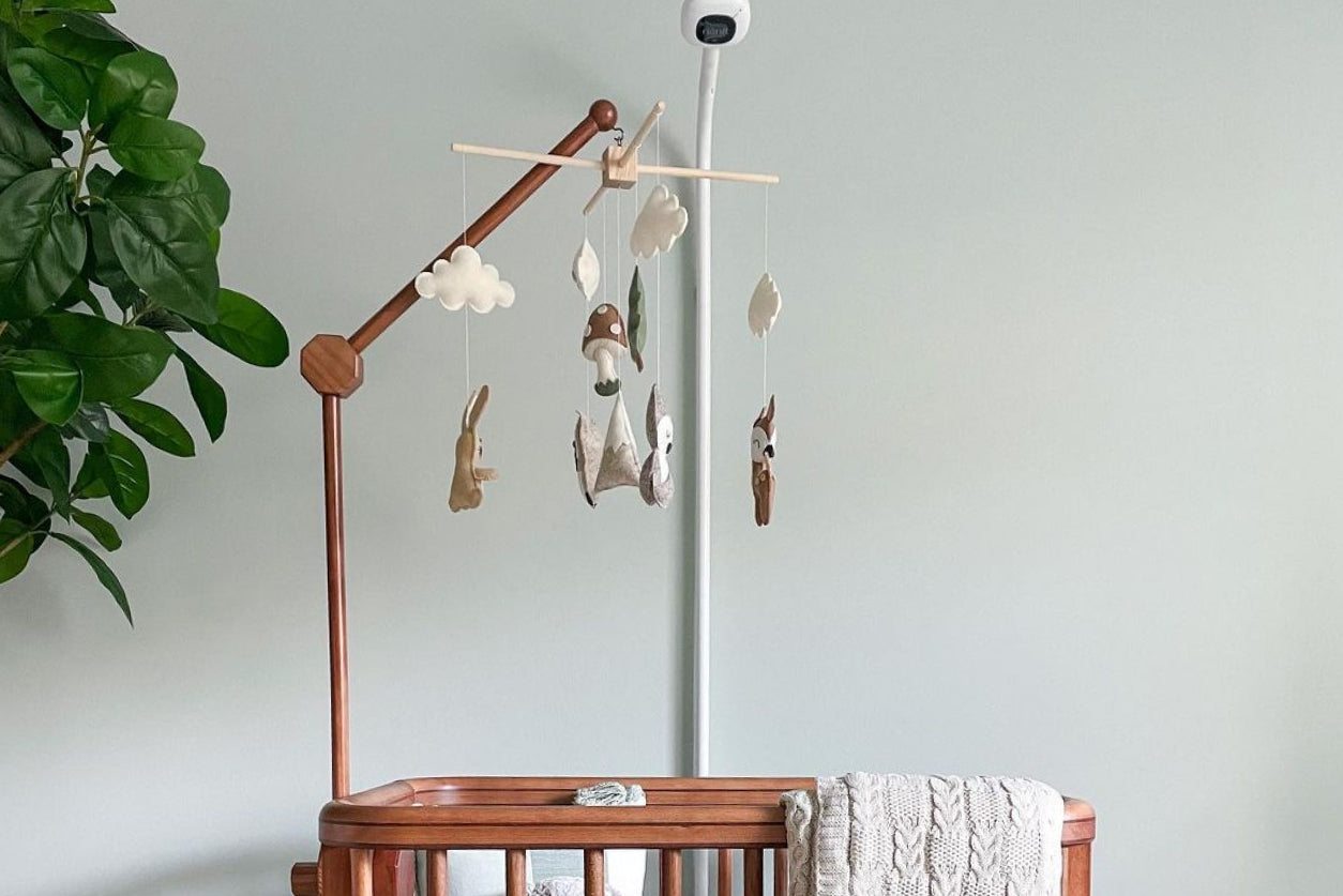 Bassinet with Nanit Pro Baby Monitor in nursery before baby shower