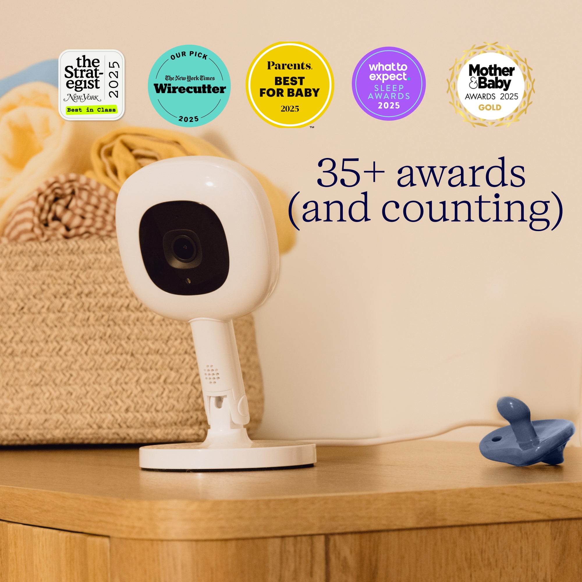 Baby monitor on a wooden surface with multiple awards displayed