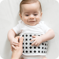 baby wearing nanit breathing band in white