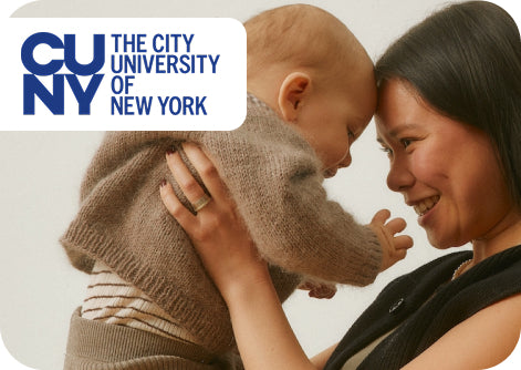Woman holding a baby with 'CUNY The City University of New York' logo in the corner.