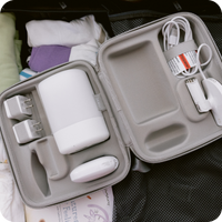 nanit sound and light machine travel case open with nanit sound and light machine and cables in travel case