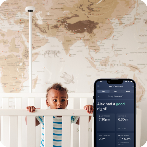 child over looking over crib with nanit Pro camera wall mount in background and mobile display in front