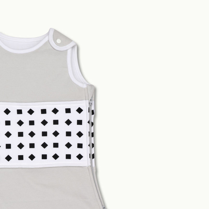 nanit heather gray sleeping bag shown zoomed in on shoulder button and zipped up on side