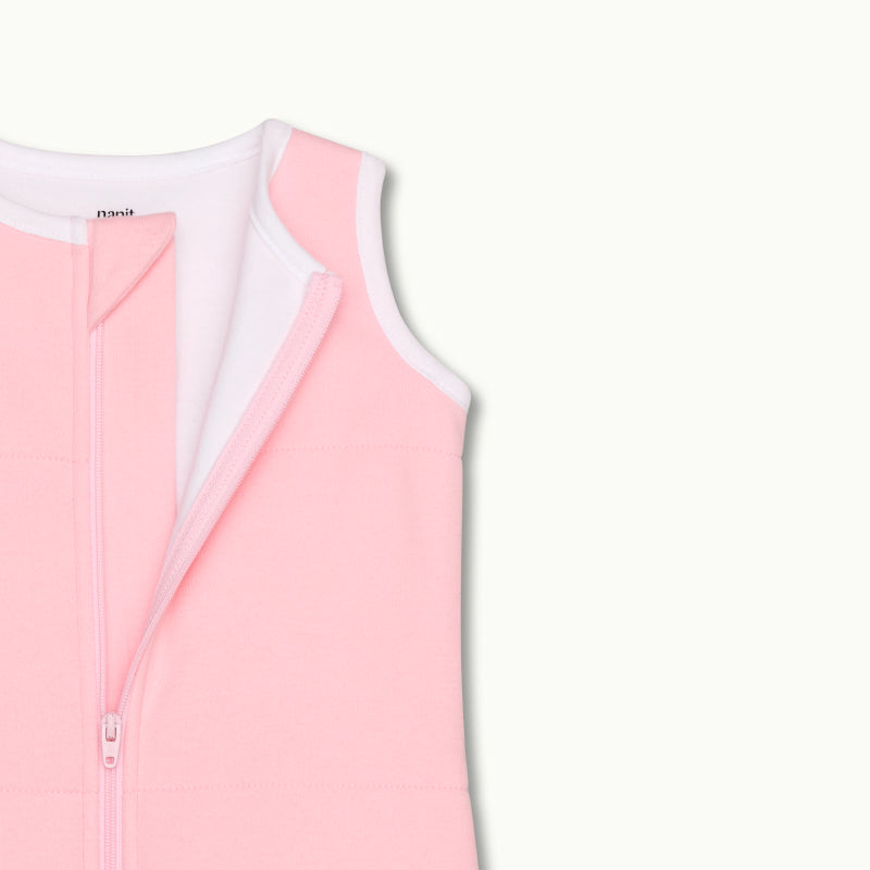 zoomed in on nickel-free snap tab zipper cover, plus protective chin zipper guard on sleeping bag in rose pink #color_rose pink