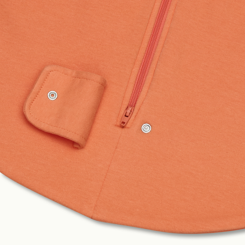 zoomed in on two-way bottom zipper on sleeping bag in cantaloupe #color_cantaloupe