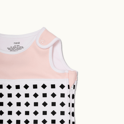 nanit blush pink sleeping bag shown zoomed in on shoulder button and zipped up on side