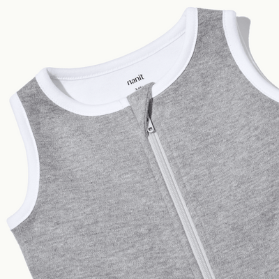zoomed in on nickel-free snap tab zipper cover, plus protective chin zipper guard on sleeping bag in heather gray
