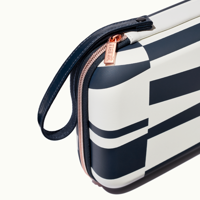 zoomed in picture of rose pink zipper and strap on abstract stripe travel case