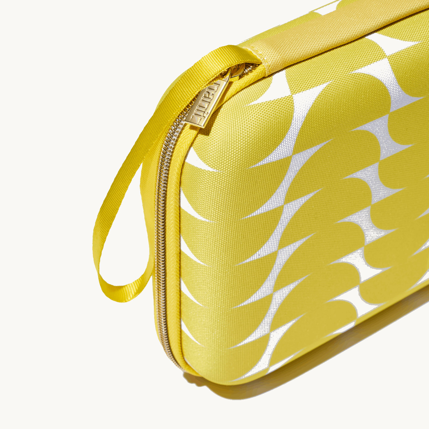 zoomed in picture of gold zipper and strap on yellow travel case #color_half moon