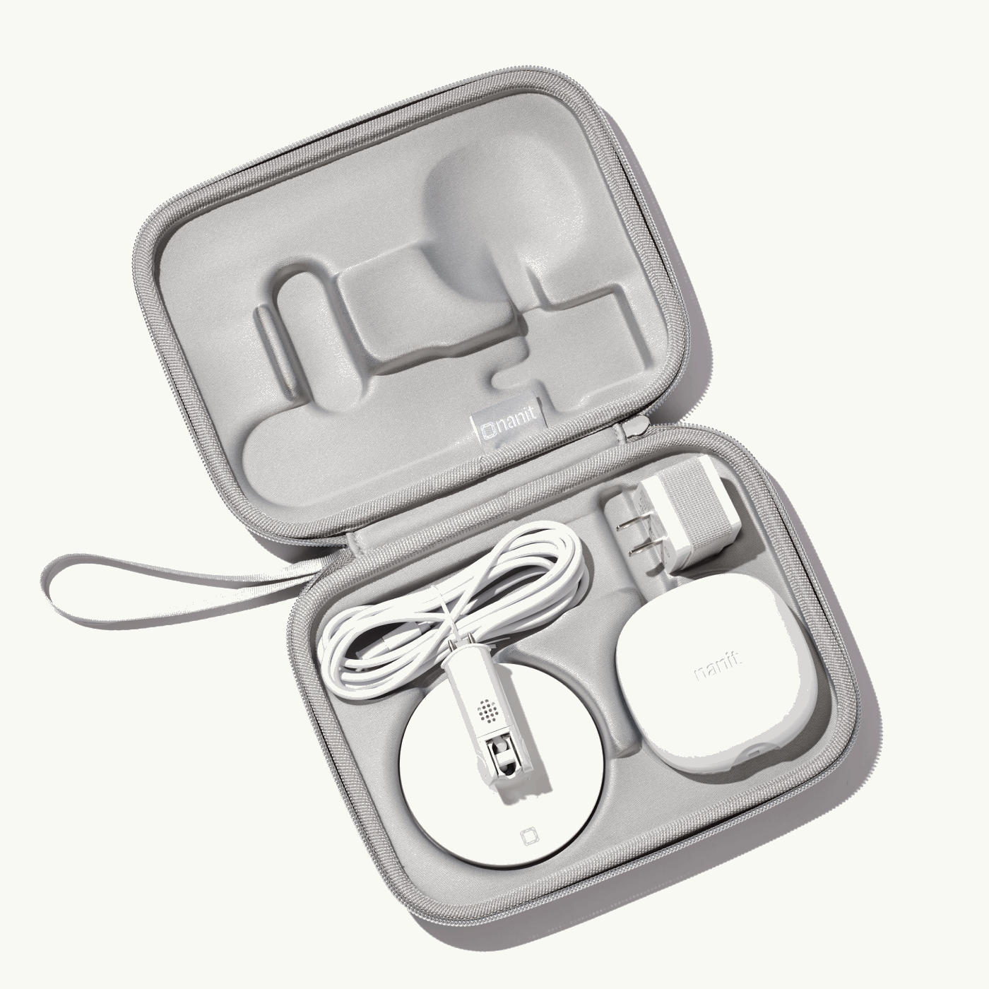 inside nanit travel case in gray with nanit pro camera, flex stand, and power adapter #color_gray