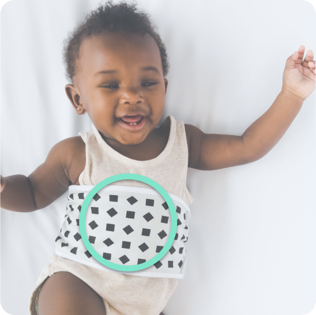 Baby wearing a sleeveless onesie with a geometric pattern and green circle on a white background
