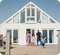 Family coming out of home on to a deck