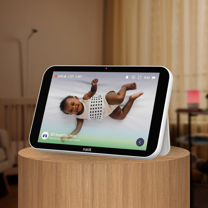 Nanit home displaying a baby on a screen in a home setting
