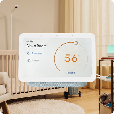 nanit baby monitor floor stand in the background with crib in front and a display of the temperature in baby's room