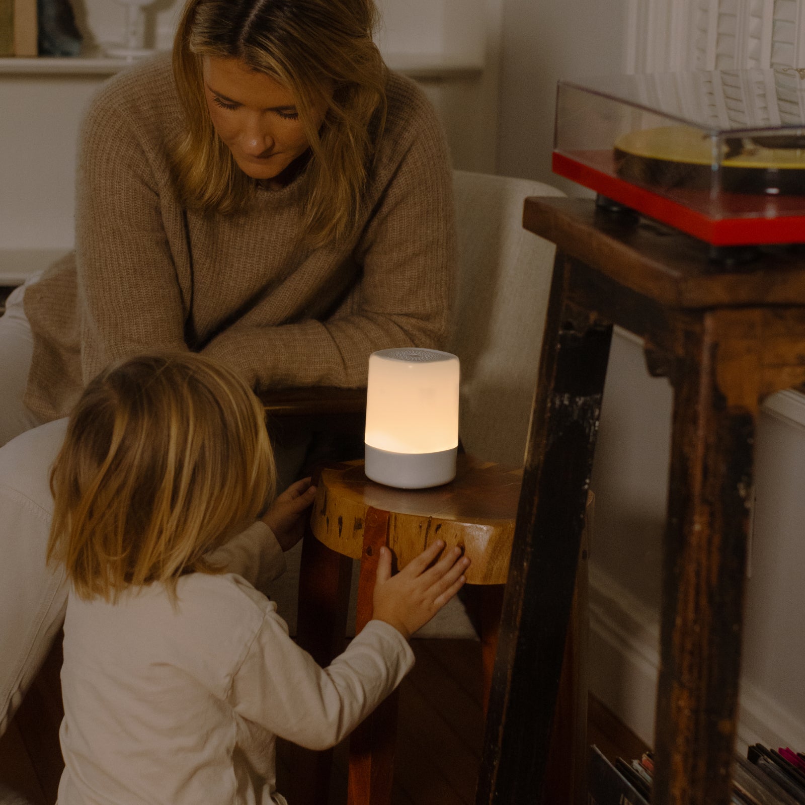 mom looking at toddler while toddler looking at nanit sound + light