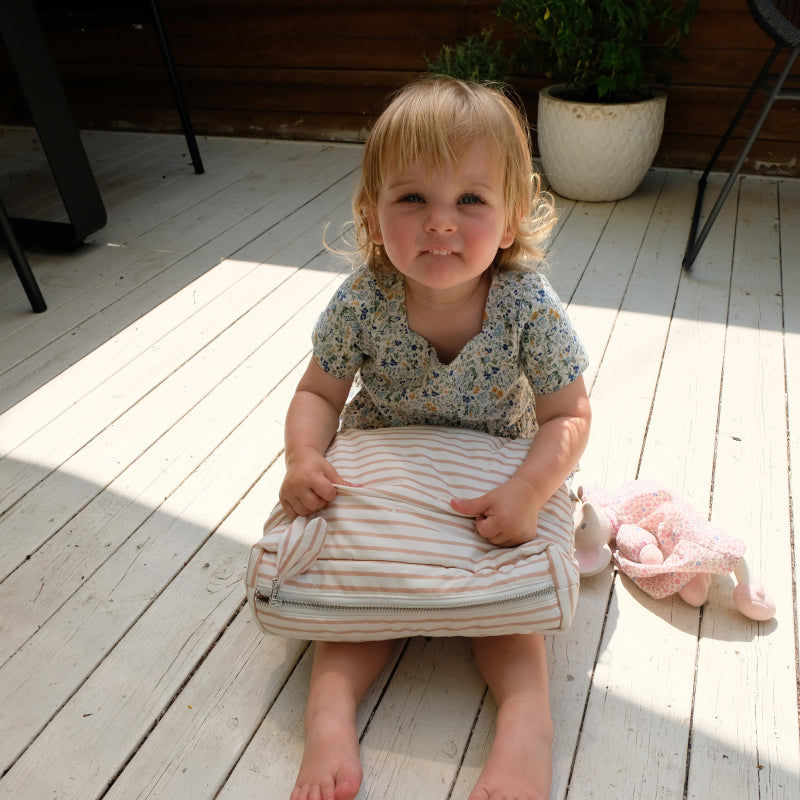 baby holding Pehr On The Go Pouch
