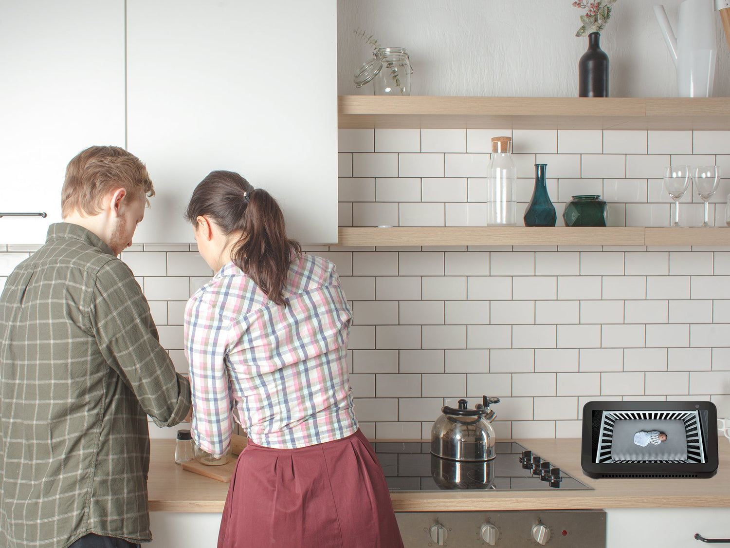 parents in kitchen with alexa showing nanit camera