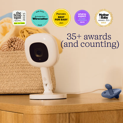 Baby monitor on a wooden surface with multiple awards displayed