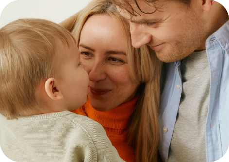 mom and dad looking at child in a loving way
