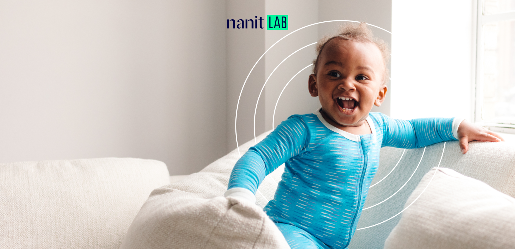 smiling child wearing nanit pajamas 