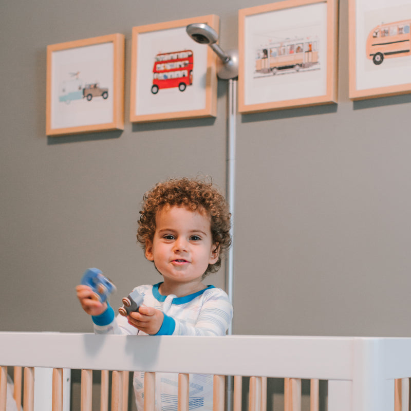 baby in crib playing with toys with silver nanit pro camera + wall mount mounted on wall #mount_wall mount