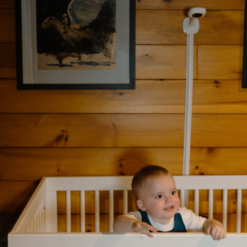 baby inside crib with nanit pro camera + wall mount behind mounted on wall #mount_wall mount