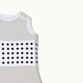 nanit  heather gray sleeping bag shown zoomed in on shoulder button and zipped up on side #color_pebble gray
