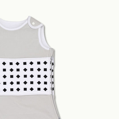 nanit  heather gray sleeping bag shown zoomed in on shoulder button and zipped up on side 