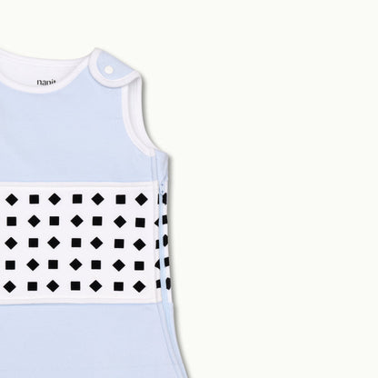 nanit powder blue  sleeping bag shown zoomed in on shoulder button and zipped up on side 