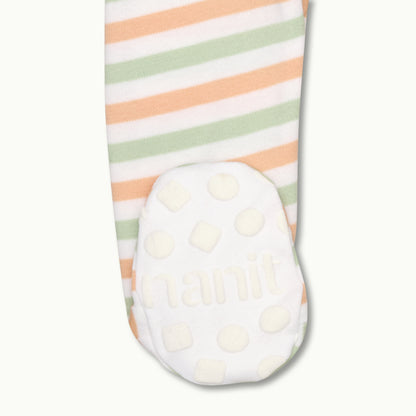 zoomed in on right feet in front view of sleep wear pajamas in apricot bold stripe showing signature foot gripper 