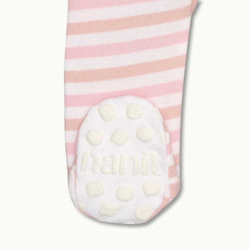 zoomed in on right feet in front view of sleep wear pajamas in rose pink stripe showing signature foot gripper #color_rose pink stripe