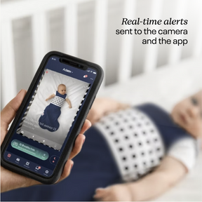 nanit app showing live screen with breathing motion monitoring. text on right showing "real-time alerts sent to the camera and the app"