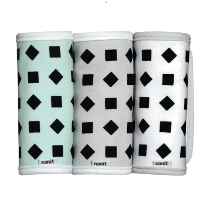 Three cylindrical products with geometric pattern packaging on a white background, branded 'nanit' 