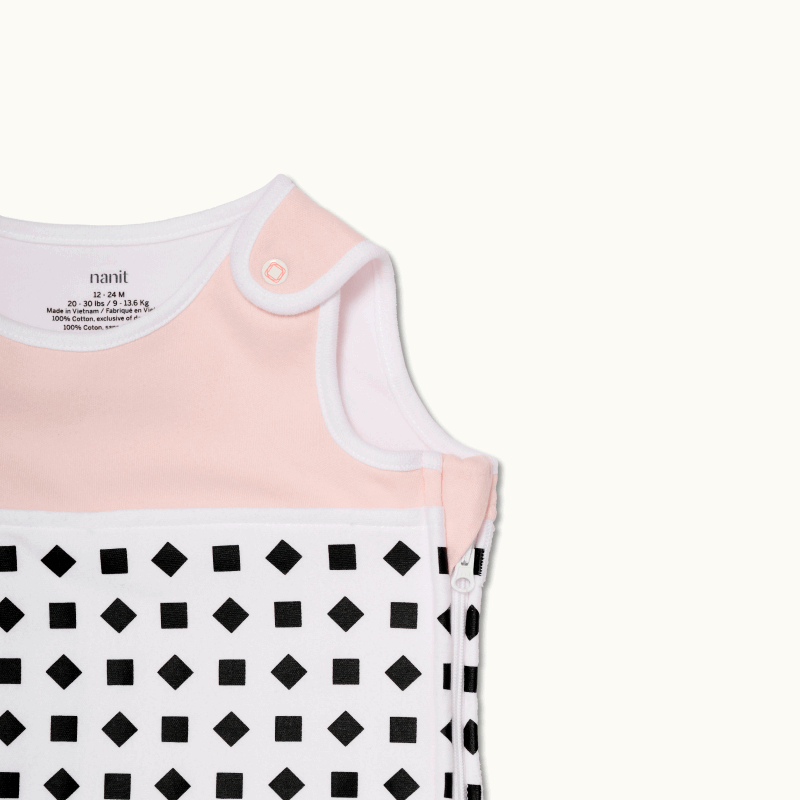 nanit blush pink sleeping bag shown zoomed in on shoulder button and zipped up on side #color_blush pink