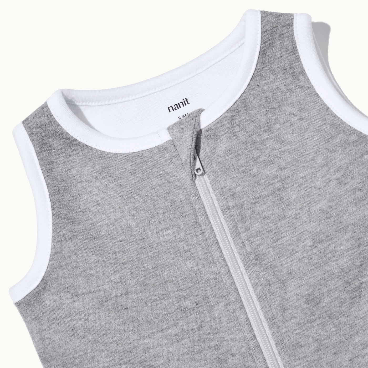 zoomed in on nickel-free snap tab zipper cover, plus protective chin zipper guard on sleeping bag in heather gray #color_heather gray