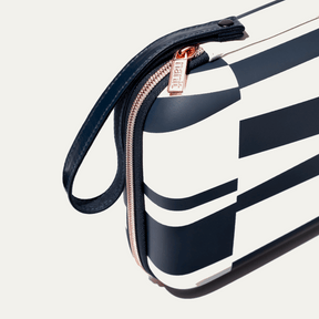 zoomed in picture of rose pink zipper and strap on abstract stripe travel case #color_abstract stripe
