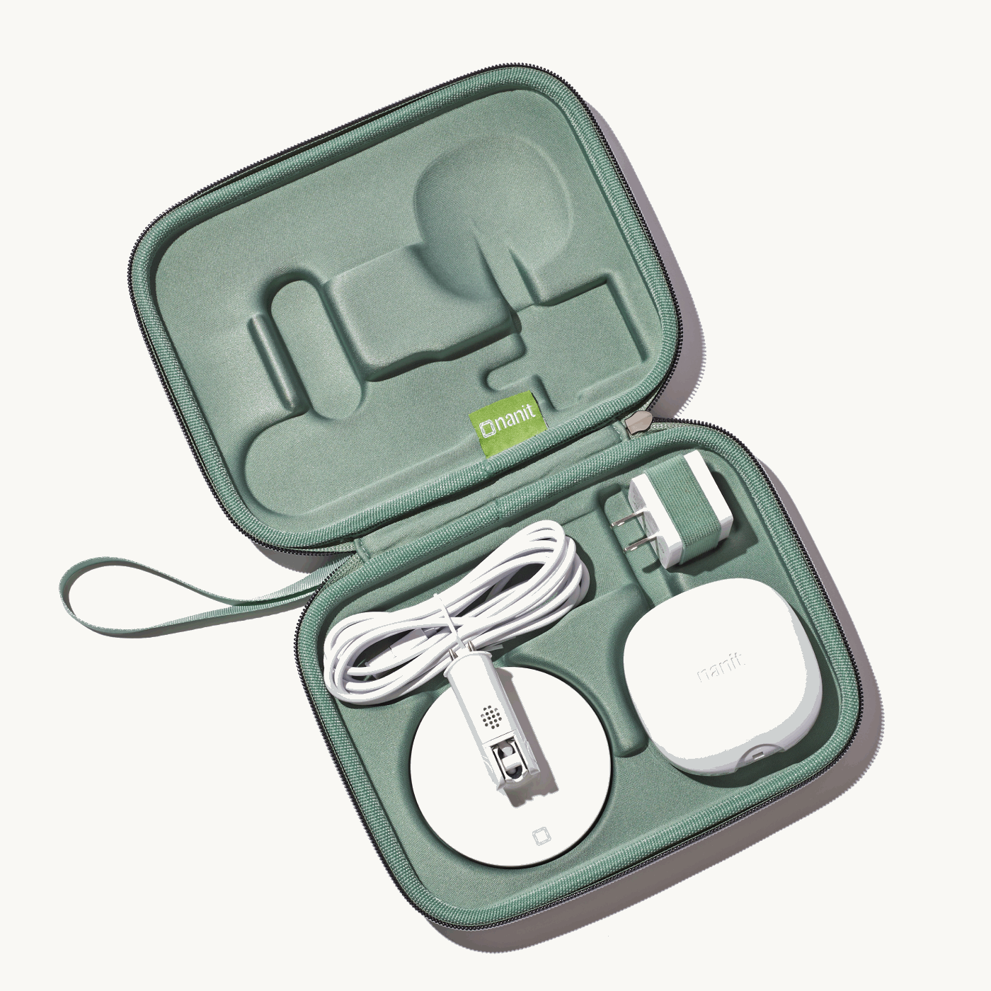 inside nanit travel case in green with nanit pro camera, flex stand, and power adapter #color_green