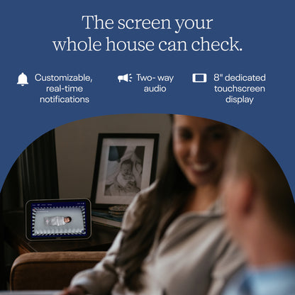 Woman and child looking at a touchscreen display with text about customizable notifications and two-way audio. 