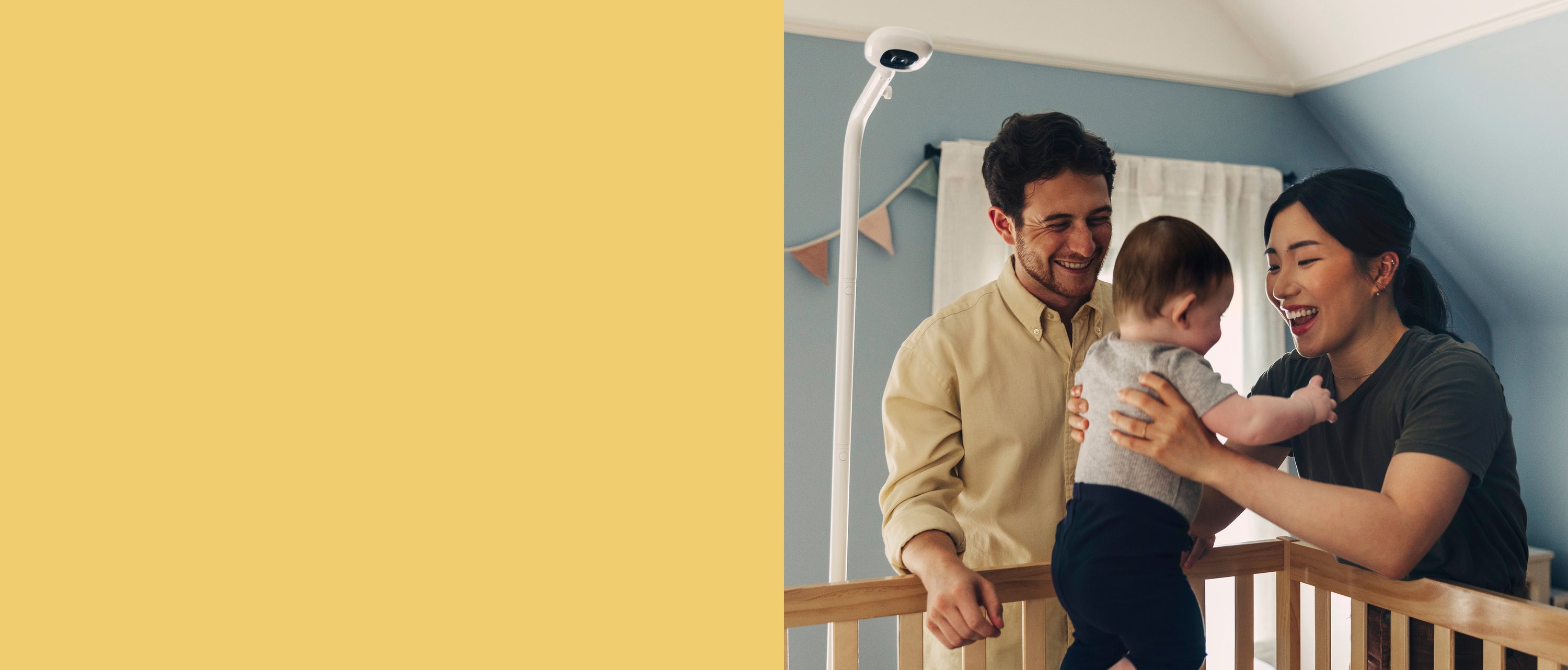 Family in a nursery with a baby and Pro Baby Monitor on Floor Stand.