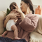 Baby wearing Coterie diaper while mom holding her baby