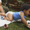 Baby crawling and wearing Coterie Diaper