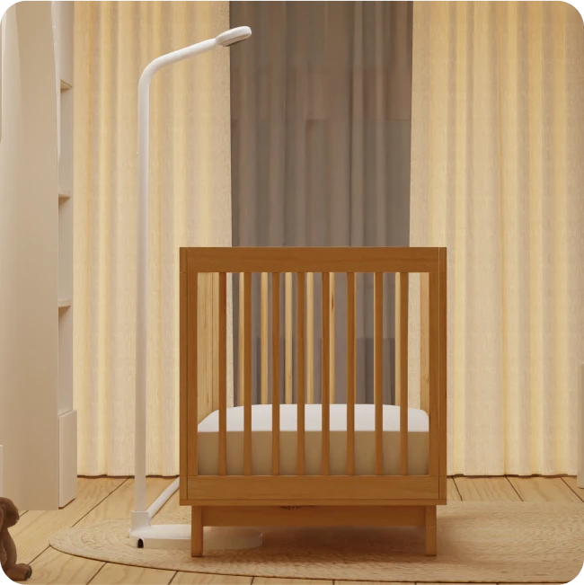 baby crib in room with nanit pro baby monitor floor stand on side of crib