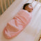 baby in nanit sleep wear swaddle in rose pink
