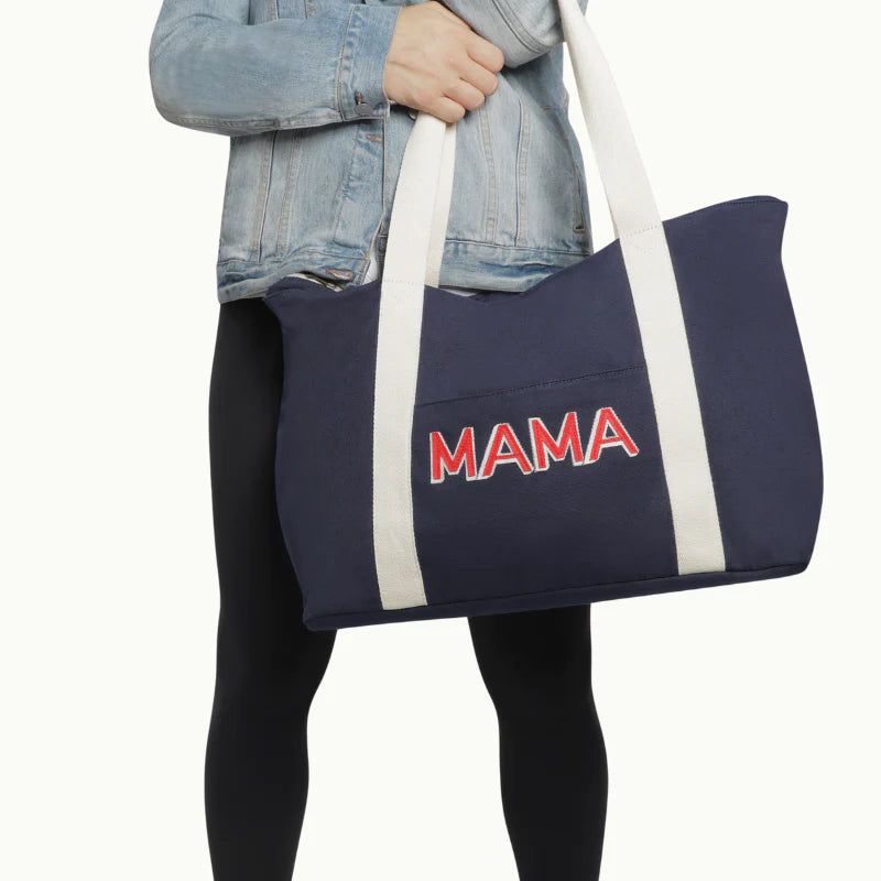 woman holding mama weekender bag