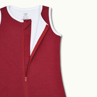 zoomed in on nickel-free snap tab zipper cover, plus protective chin zipper guard on sleeping bag in burgundy 