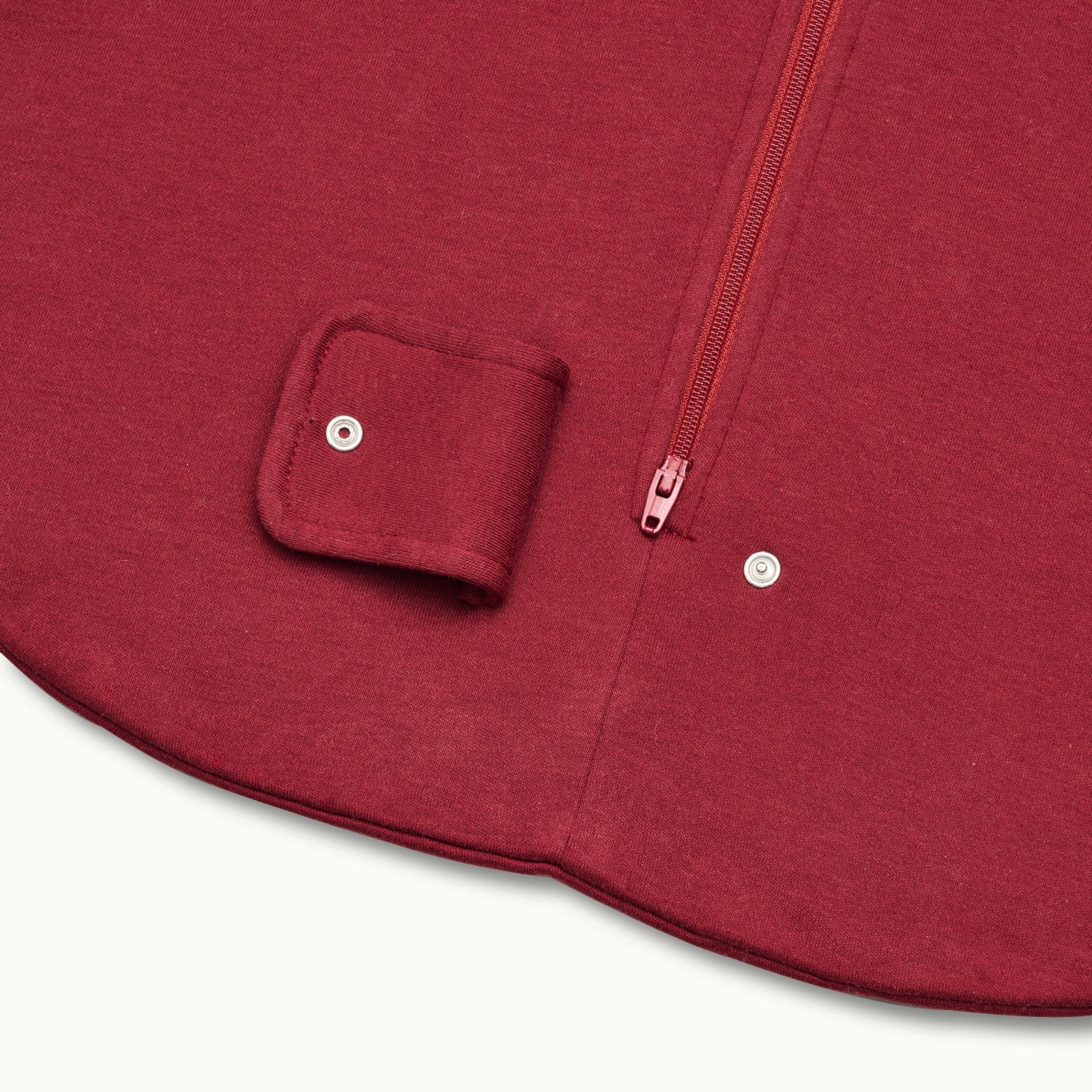 zoomed in on two-way bottom zipper on sleeping bag in burgundy #color_burgundy