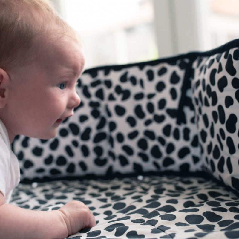 Baby looking at Etta Loves Animal Print Sensory Strip