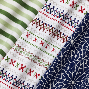 zoomed in on nanit 2-piece sleep wear holiday pajamas in evergreen bold stripe, fair isle, and bright star