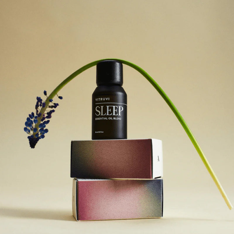 Vitruvi Sleep Essential Oil Blend on top of boxes