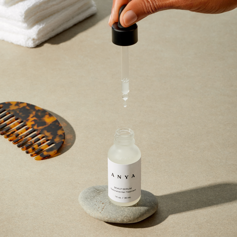 anya scalp serum liquid dripping in bathroom setting